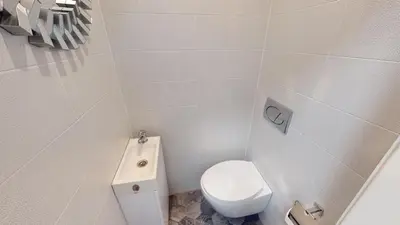 a white bathroom with a toilet and a sink at A Lovely 2BR Apartment in the heart of Sofia - NDK in Sofia