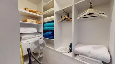 a walk in closet with a fan and towels at A Lovely 2BR Apartment in the heart of Sofia - NDK in Sofia