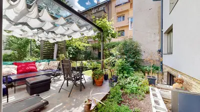 an outdoor patio with a couch and a table at A Lovely 2BR Apartment in the heart of Sofia - NDK in Sofia