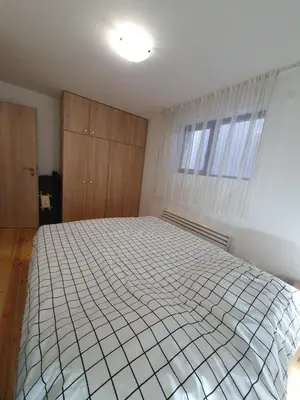 a bedroom with a large white bed in it at Mila Apartment in Bansko