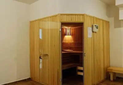a room with a wooden closet with a desk at Ski to door at Mountain View 1BR condo Bansko in Bansko