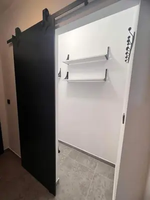 a white closet with a black door and shelves at The Tower - Lovely apartment @ Bansko Royal Towers in Bansko