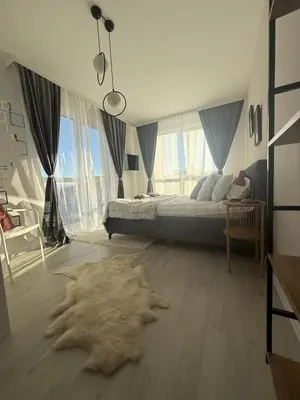 a bedroom with a bed and a large fur rug at The Tower - Lovely apartment @ Bansko Royal Towers in Bansko