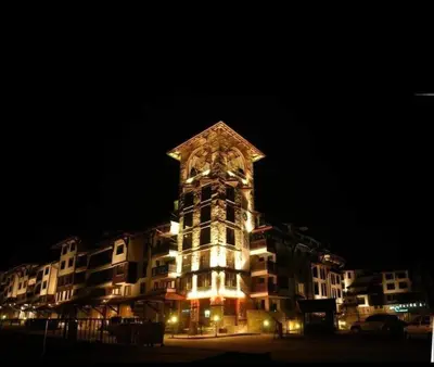 a tall building with a clock tower at night at The Tower - Lovely apartment @ Bansko Royal Towers in Bansko
