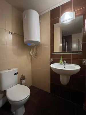 a bathroom with a toilet and a sink at Bansko Royal Towers 253 in Bansko
