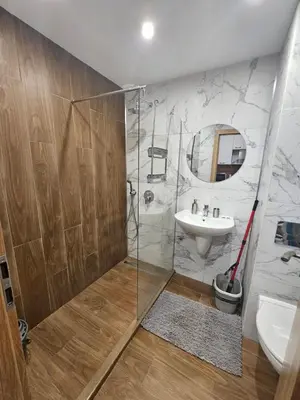 a bathroom with a shower and a sink and a mirror at Rustic Mountain Apartment - A55 in Borovets
