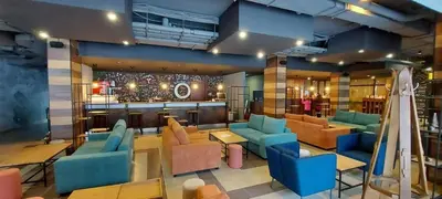 a lobby with blue and orange furniture and a bar at Rustic Mountain Apartment - A55 in Borovets