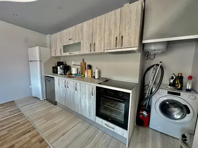 a kitchen with a washing machine and a washer at Central Vista Apartment by MIT in Sofia