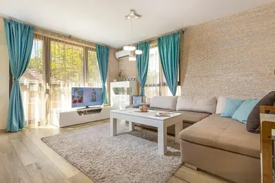 a living room with a couch and a table at 2BR apartment ,10 minutes walk to TOP Center in Plovdiv