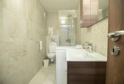 a bathroom with a sink and a toilet at Cozy Apartment with Mountain View & Parking in Sofia