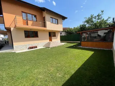 a house with a lawn in front of it at Villa Stoyanovata Kashta in Samokov