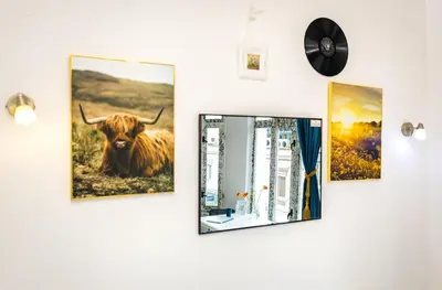a wall with paintings of a cow on it at House Of History , Rooms in the Main Street Plovdiv in Plovdiv