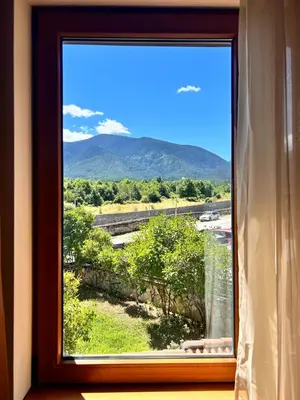 a window with a view of a mountain view at Bansko Downtown R LUX apartment in Bansko