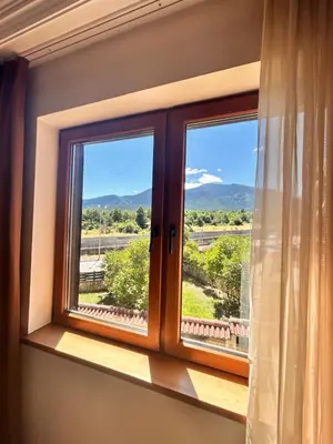 a window with a view of the mountains at Bansko Downtown R LUX apartment in Bansko