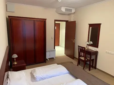 a bedroom with a bed and a chair and a desk at Bansko Downtown R LUX apartment in Bansko