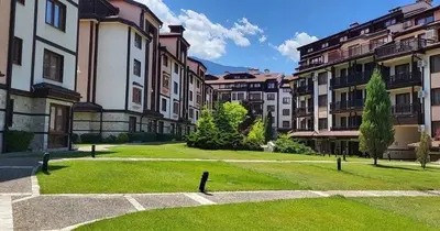 a large grassy yard in a city with buildings at Bansko Downtown R LUX apartment in Bansko