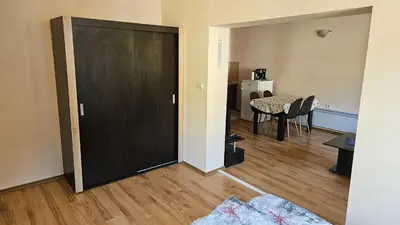 a black door in a living room with a table at Апартамент Николови Пампорово in Pamporovo
