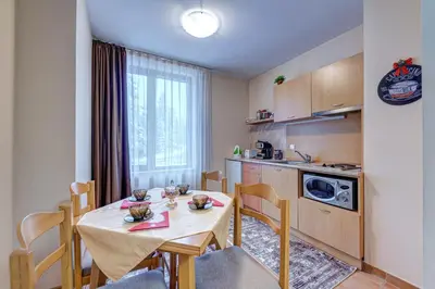 a kitchen and dining room with a table and chairs at Cozy and Cute 1BD Apartment in The Castle Complex by Flat Mаnager in Pamporovo