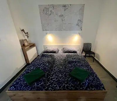a bedroom with a bed with a blue comforter at The rainbow 2 in Sofia