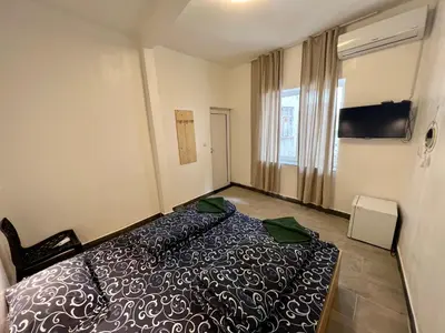 a hotel room with a bed and a window at The rainbow 2 in Sofia