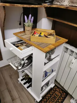 a kitchen island with a wooden counter top and drawers at The Music House - Exclusive Studio in the Heart of Sofia by Flat Mаnager in Sofia