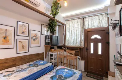 a bedroom with two beds and a door at The Music House - Exclusive Studio in the Heart of Sofia by Flat Mаnager in Sofia