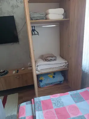 a room with a bunk bed and a tv on a shelf at Студио Еми in Chepelare