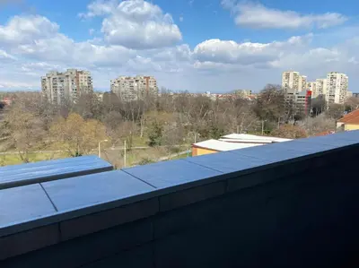 a roof of a building with buildings in the background at Modern 1BR Apartment with Garden View & Free street parking in Plovdiv