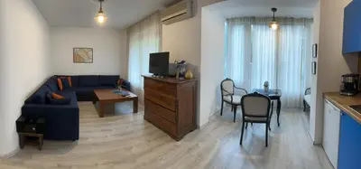 a living room with a blue couch and a table at Eli's cozy place in Sofia