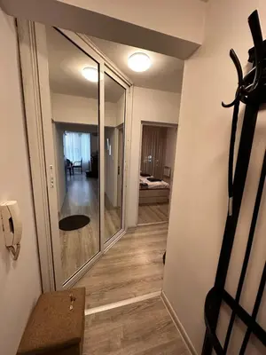 a hallway leading to a room with a mirror at Eli's cozy place in Sofia