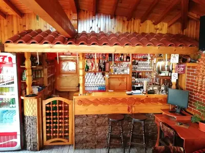 a bar in a restaurant with a bar stool at Kovacha Guest House in Raduil