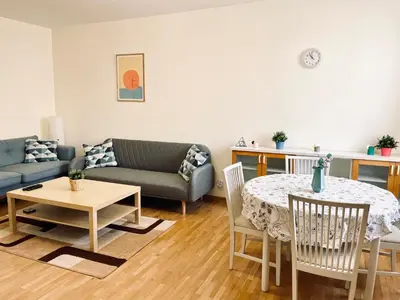 a living room with a table and a couch at 2-BDR Flat Near the Mall, Spacious & Cozy by Flat Mаnager in Sofia