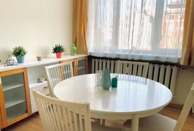 a white table and chairs in a room with a radiator at 2-BDR Flat Near the Mall, Spacious & Cozy by Flat Mаnager in Sofia