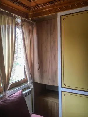 a living room with a window and a couch at Стаи за гости Бащино огнище in Koprivshtitsa