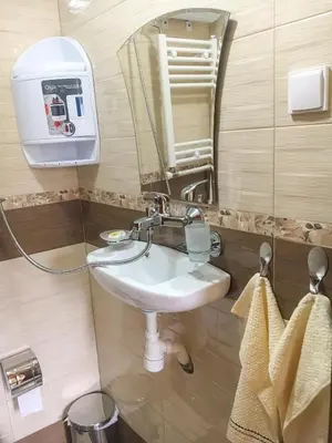 a bathroom with a sink and a mirror at Стаи за гости Бащино огнище in Koprivshtitsa