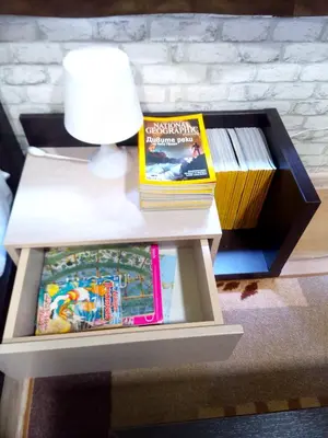 a table with a lamp and books on it at Апартамент в центъра на София - plus Free Vouchers in Sofia