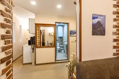 a living room with a door and a mirror at Snow Line Suites SLS in Bansko