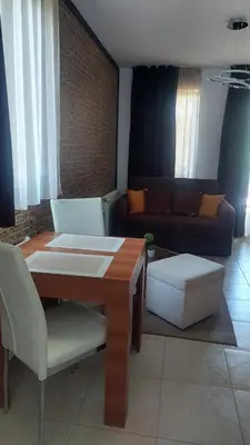 a living room with a couch and a table and chairs at Apartment in Bansko in Bansko