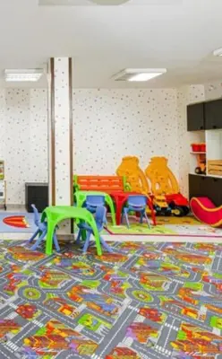 a room with a play room with chairs and a rug at Apartment in Bansko in Bansko