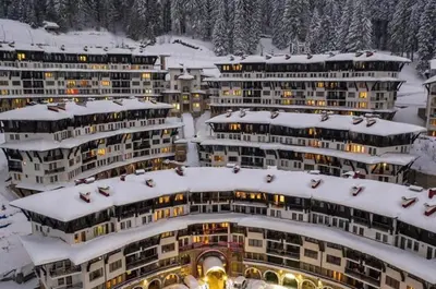 a group of buildings with snow on them at Apartments WinterFell ,Grand Monastery ,Pamporovo in Pamporovo
