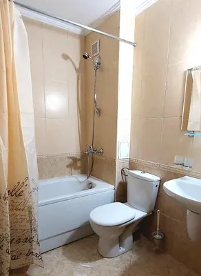 a bathroom with a toilet and a tub and a sink at Apartments WinterFell ,Grand Monastery ,Pamporovo in Pamporovo