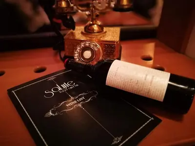 a bottle of wine sitting on top of a table at Apartments WinterFell ,Grand Monastery ,Pamporovo in Pamporovo