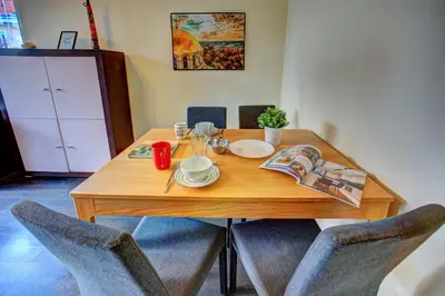 a wooden dining room table with two chairs at 1BD Nest in the heart of a traditional Sofia by Flat Mаnager in Sofia