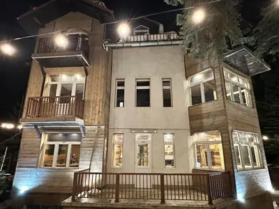 a large building with lights on top of it at night at The Forest Villa Borovets by BookVillaBG in Borovets