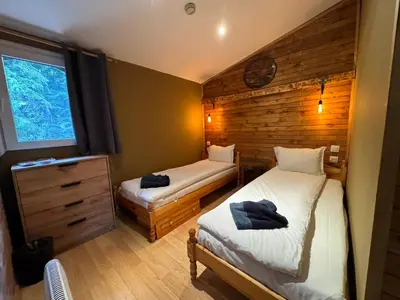 a small bedroom with two beds and a window at Chalet Iskar Borovets by BookVillaBG in Borovets