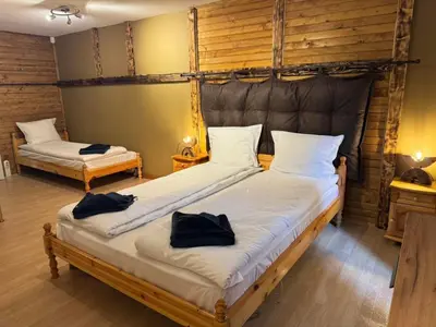 a bedroom with two beds with towels on them at Chalet Iskar Borovets by BookVillaBG in Borovets