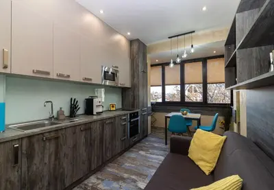a kitchen with a couch and a table with chairs at Unique Central 1 Bedroom Flat in Sofia