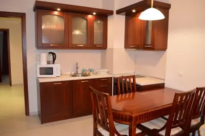a kitchen with a table and a microwave at Elinor Apartment - Downtown in Bansko