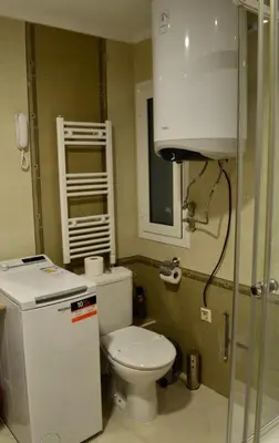 a small bathroom with a toilet and a sink at Elinor Apartment - Downtown in Bansko