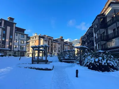 a city street covered in snow with buildings at Elinor Apartment - Downtown in Bansko